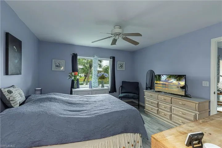 Bedroom with wood finished floors and ceiling fan