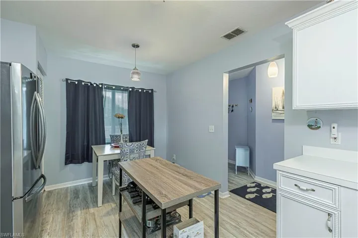 Dining space with light wood-type flooring and baseboards