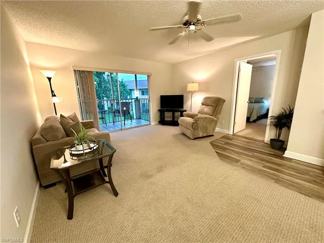 Living room with ceiling fan and lanai access - all furniture in photos included