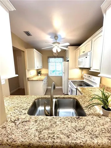 Updated kitchen with granite counters &  ceiling fan