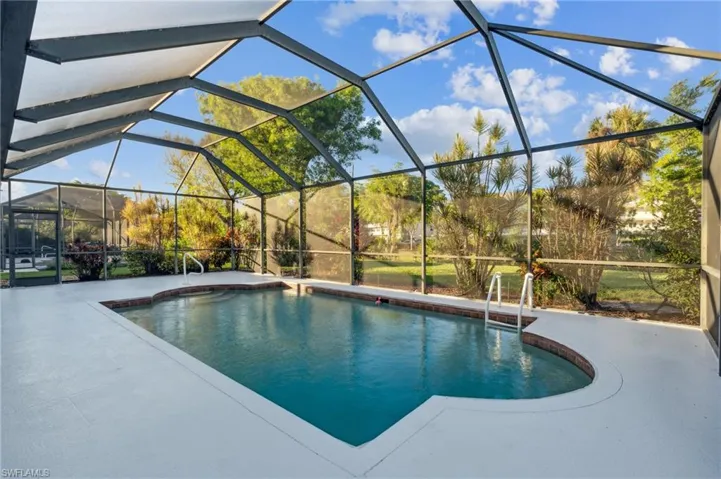 View of pool featuring a patio and screen lanai.