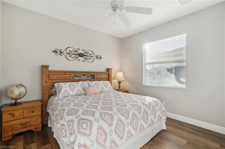 Bedroom featuring ceiling fan, and dark wood-like flooring