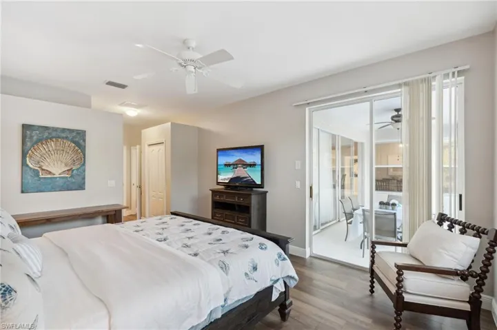 Owner's suite with glass sliders to pool, a dual closets, and wood-style flooring throughout.