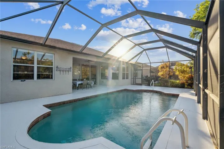 Swimming pool featuring a Screened in lanai, ceiling fan, and a patio area great for entertaining!