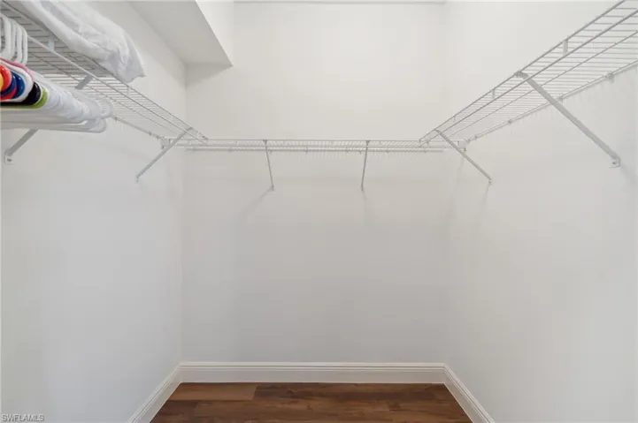 Walk in closet featuring wood-type flooring