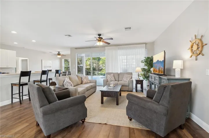 Living room featuring Newer wood-style floors throughout living areas & bedrooms.