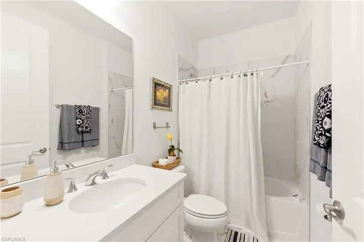 Full bath with vanity and shower / bath combo