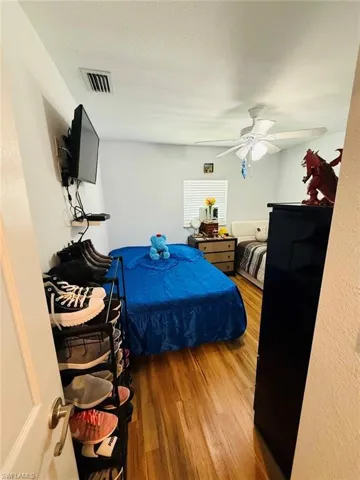 Bedroom featuring wood finished floors and ceiling fan