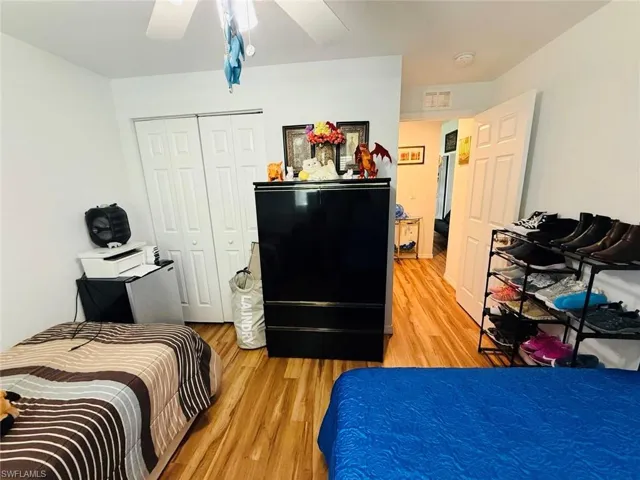 Bedroom featuring light wood-type flooring, a closet, and ceiling fan