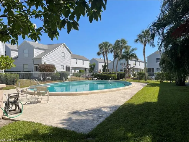 View of pool featuring a lawn and a patio