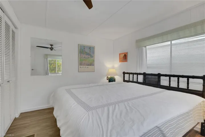 Bedroom featuring wood finished floors, a ceiling fan, and a closet