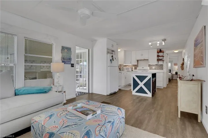 Living area with light wood-style flooring and ceiling fan