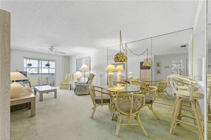 Carpeted dining area with a breakfast bar area