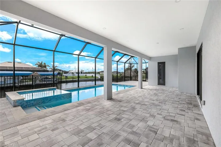 heated pool and spa with doorway to pool bath