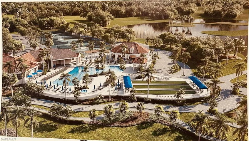 Drone / aerial view of a nearby body of water and a pool area