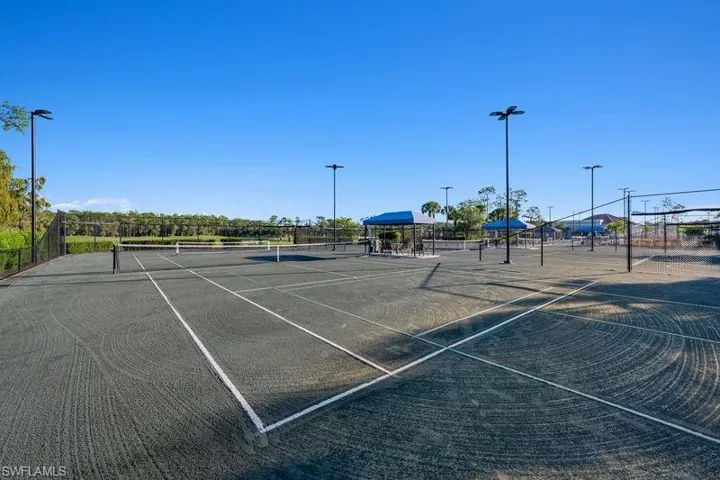 View of tennis court featuring community basketball court