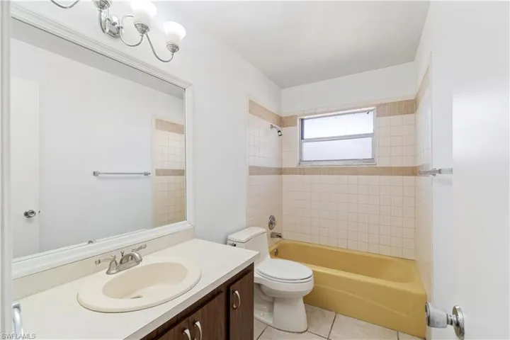 Guest bathroom between guest bedrooms in main living home. Full bathroom with shower/tub combo and tile floors