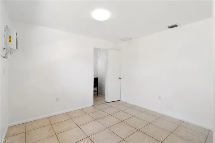 Second primary bed room attached to secondary living space for rental income or multi-generational family with light tile patterned floors