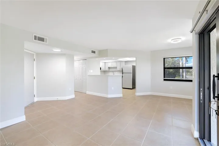 Spare room featuring baseboards and light tile patterned floors