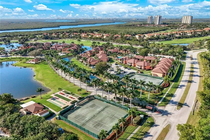Aerial view of residential area with a nearby body of water and a golf course