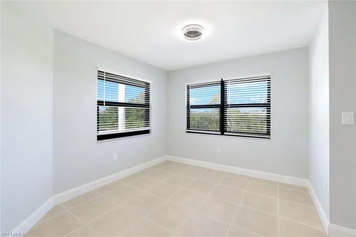 Unfurnished room with healthy amount of natural light and light tile patterned flooring