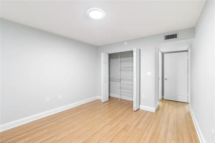 Unfurnished bedroom with a closet and light wood finished floors