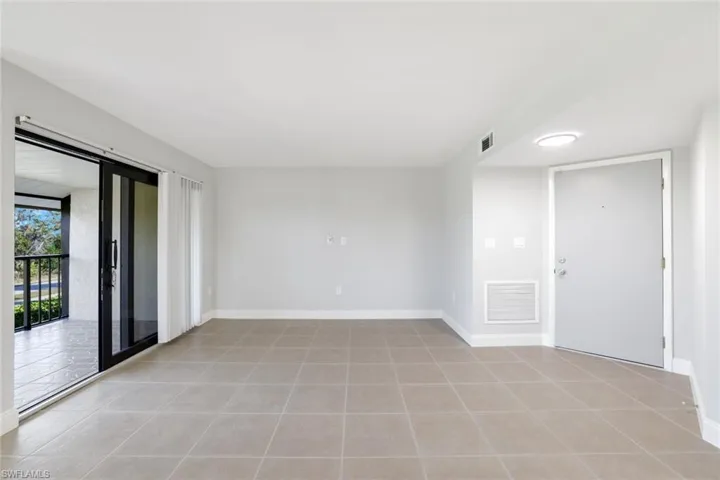 Empty room with light tile patterned floors
