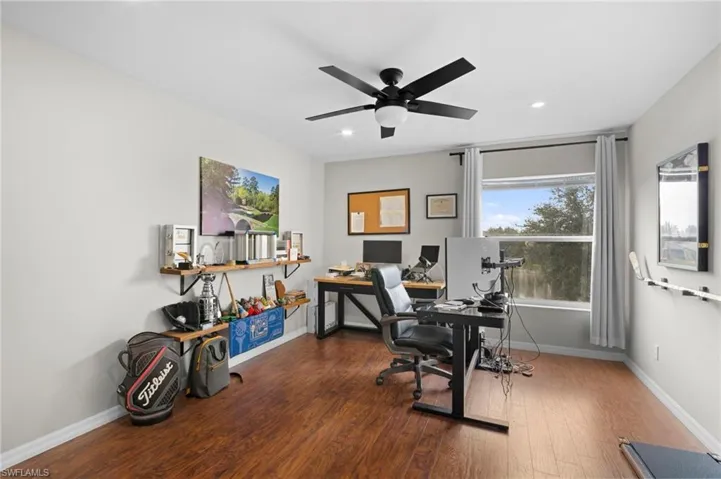 Office space featuring dark wood-type flooring, a ceiling fan, and recessed lighting