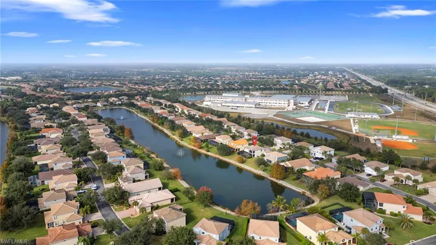 View of property location with a nearby body of water and nearby suburban area