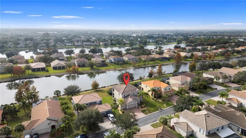 Aerial perspective of suburban area with a nearby body of water
