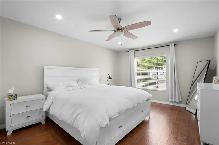 Bedroom featuring dark wood-style floors, recessed lighting, and a ceiling fan