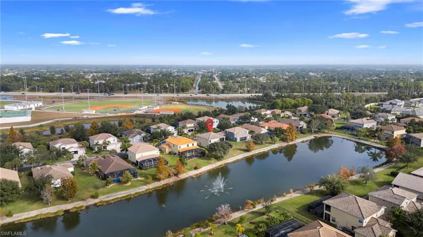 Aerial perspective of suburban area featuring a large body of water