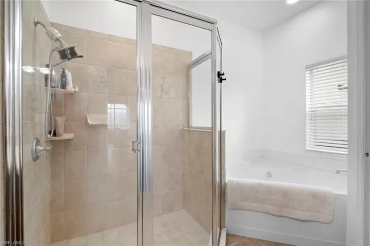 Full bathroom featuring a stall shower and a bath