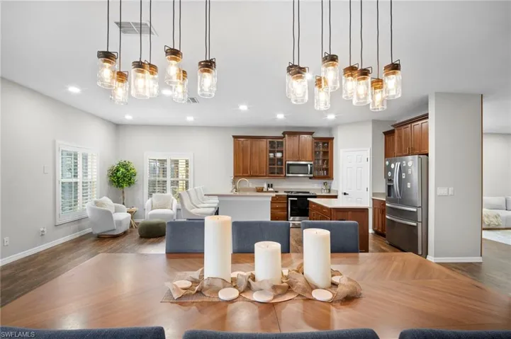 Dining space featuring a chandelier, dark wood finished floors, and recessed lighting