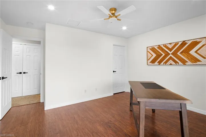 Office featuring dark wood finished floors, recessed lighting, and a ceiling fan