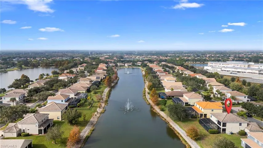Aerial perspective of suburban area featuring a large body of water