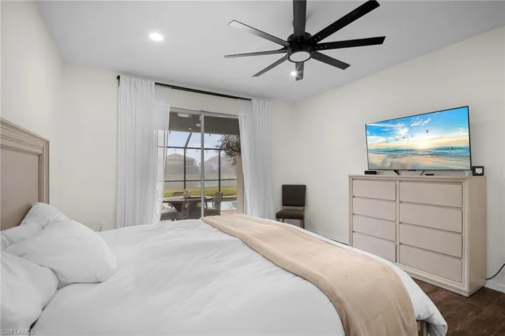 Bedroom with access to outside, wood finished floors, a ceiling fan, and recessed lighting