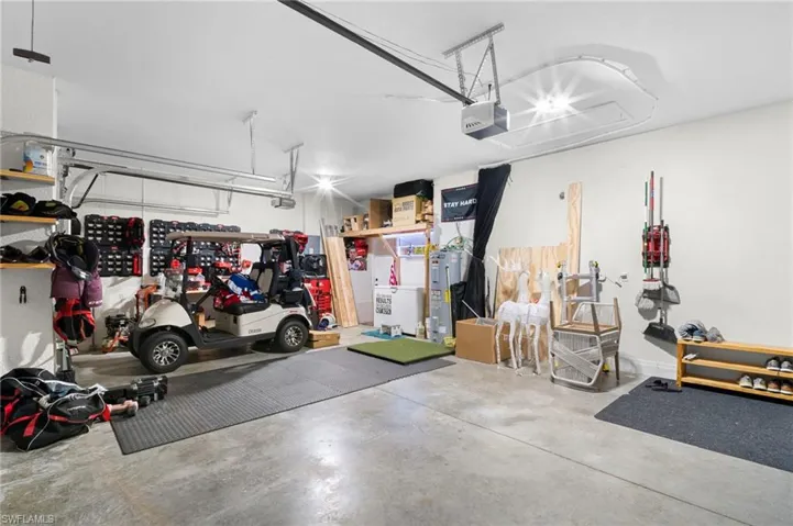 Garage with electric water heater and a garage door opener