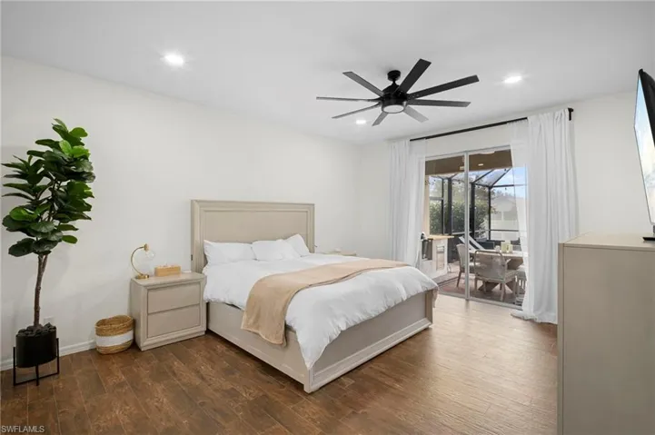 Bedroom featuring access to outside, wood finished floors, a ceiling fan, and recessed lighting