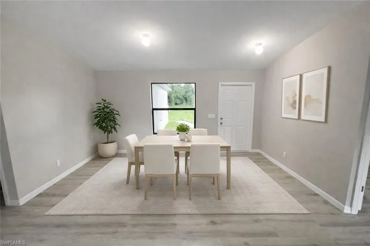 Dining area featuring light wood-type flooring and vaulted ceiling