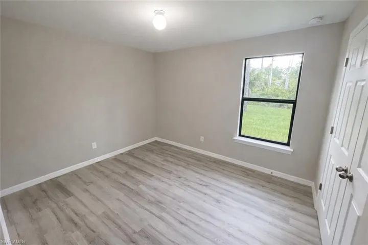 Unfurnished bedroom with light wood-style flooring and baseboards