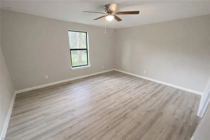 Unfurnished room with light wood-type flooring and ceiling fan