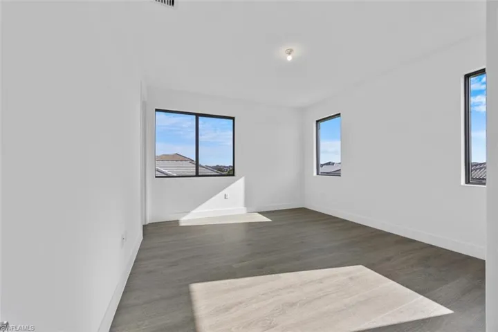 Spare room with baseboards and a healthy amount of sunlight