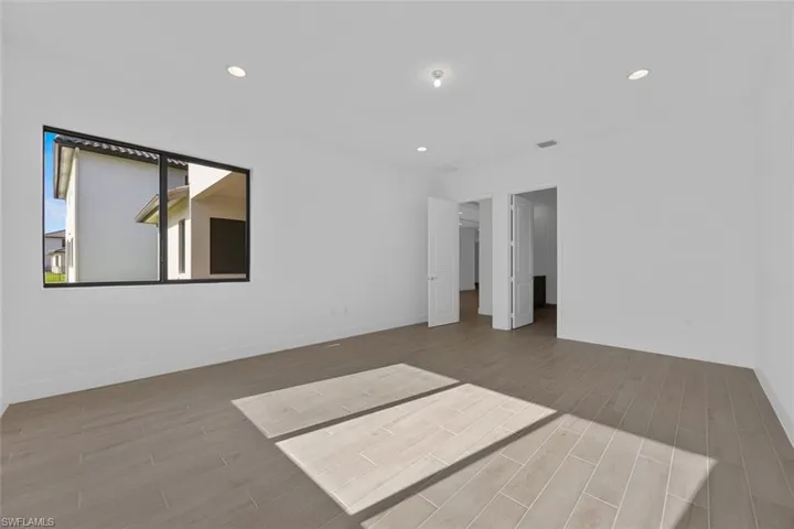 Unfurnished bedroom with baseboards, recessed lighting, and wood finished floors