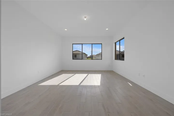 Unfurnished room featuring recessed lighting, baseboards, and light wood-type flooring