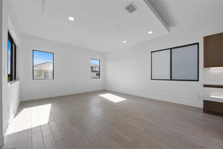 Spare room featuring visible vents, recessed lighting, light wood-style flooring, and baseboards