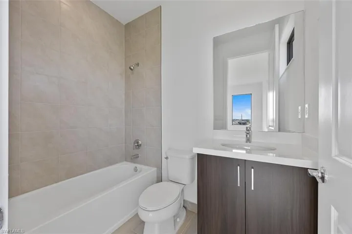 Bathroom featuring vanity, bathtub / shower combination, and toilet