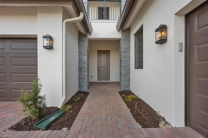 Entrance to property featuring stucco siding