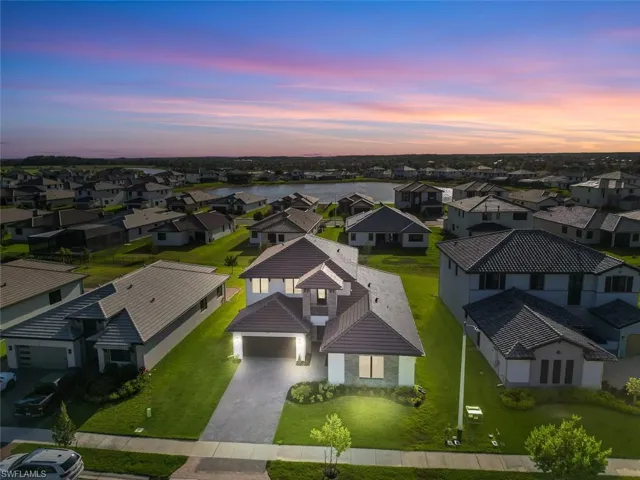 Aerial view at dusk featuring a residential view