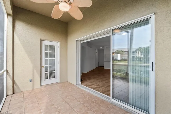 Unfurnished sunroom featuring ceiling fan